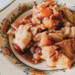 a dessert bowl, with pumpkin pecan bread pudding and cinnamon syrup
