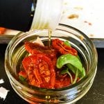 A jar of food on a table, with Tomato