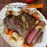 A plate of food on a table, with Pot roast and Beef