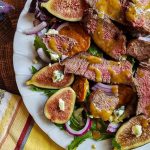A plate of food on a table, with Salad and Beef