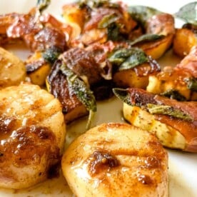 scallops seared in a hot pan with squash prepared saltimbocca style