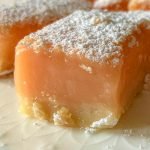 close up of Blissful And Indulgent Creamy Pink Grapefruit Bars on white plate