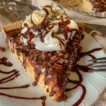 slice of pie on a white plate, with peanut butter and chocolate