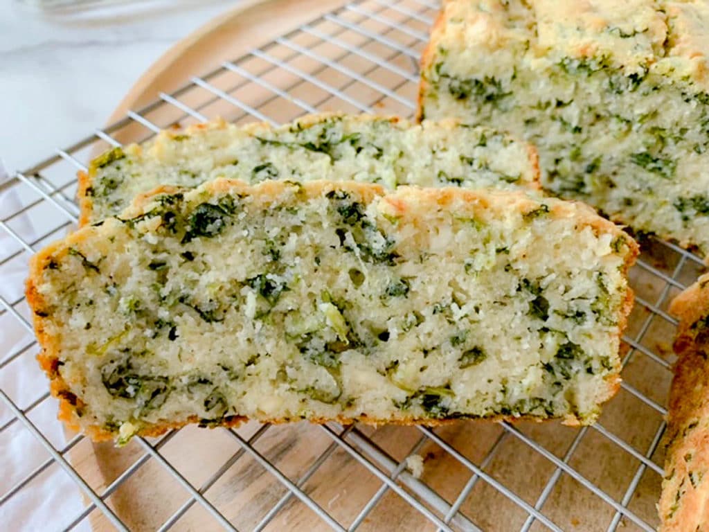 a slice of Spinach Feta Cheese Bread cooling on a rack