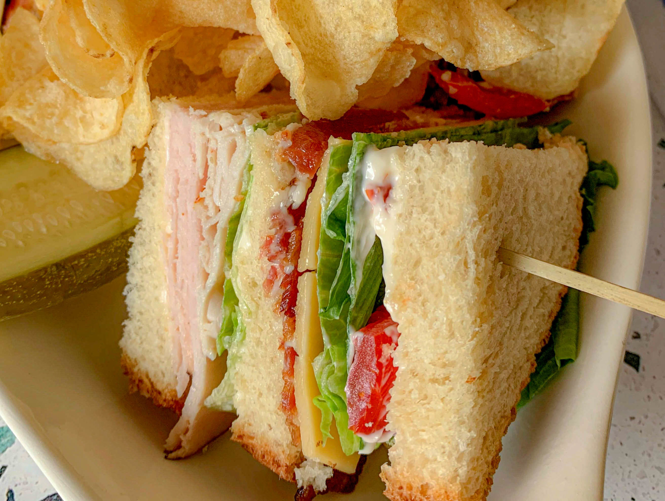 a wedge of a sandwich, with potato chips