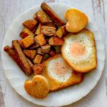 featured image for oven baked home fries recipe with savory sausages and sunny eggs