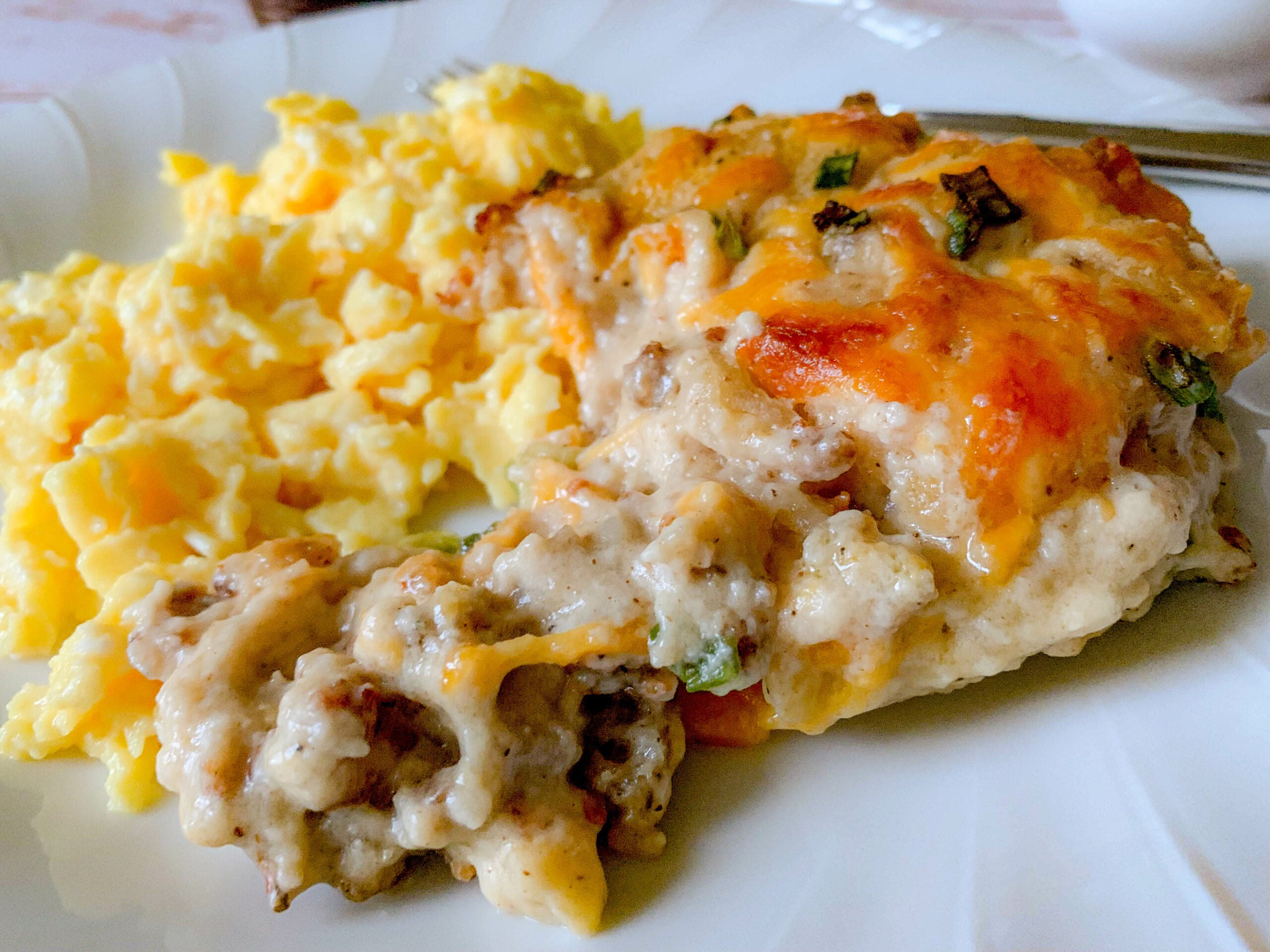 close up of a white plate, with Bob Evans Sausage Gravy Recipe and scrambled eggs