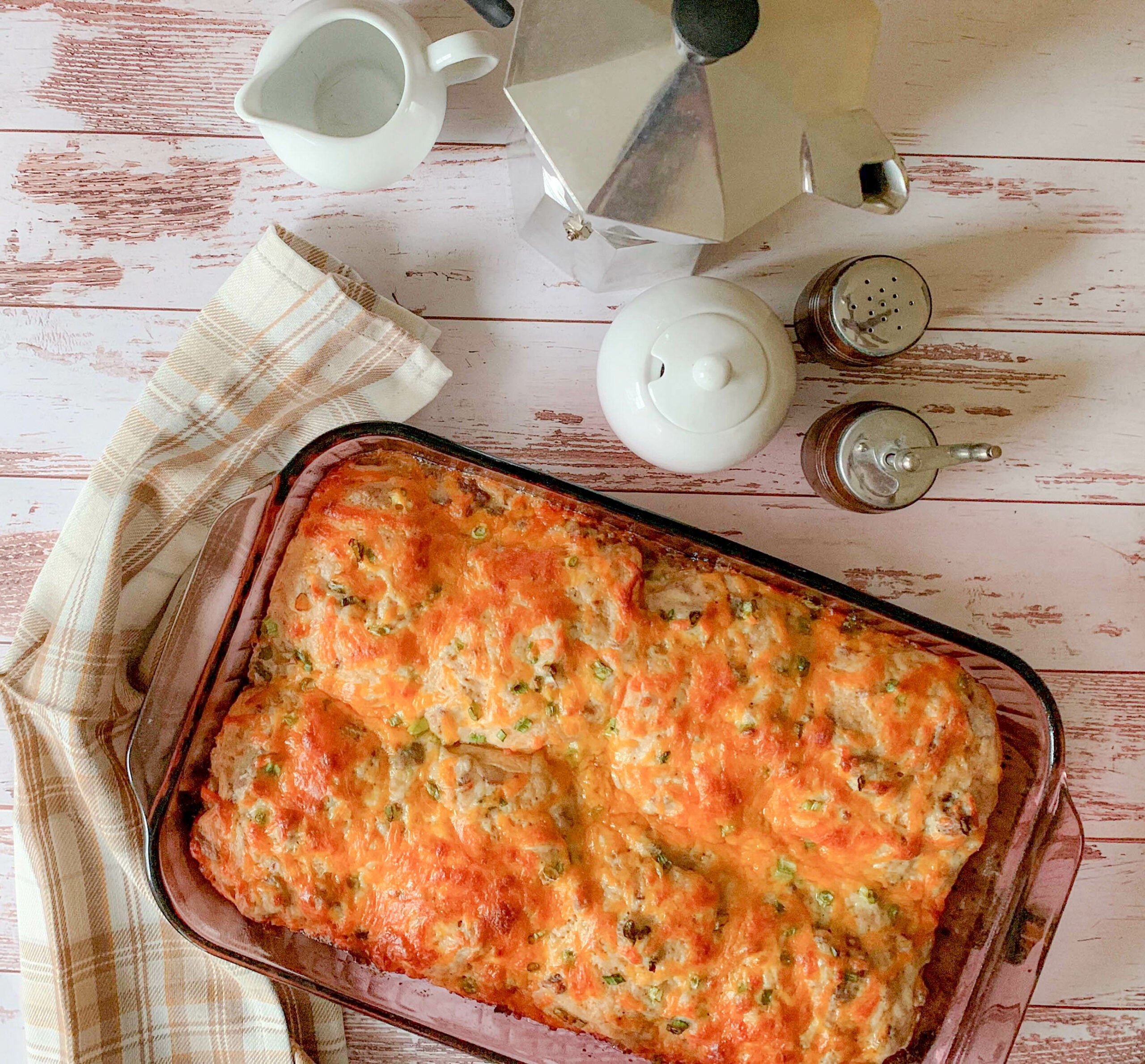 a casserole dish, with biscuits and gravy and cheese