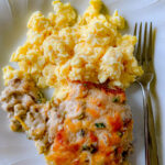 a white plate, with Bob Evans Sausage Gravy Recipe and scrambled eggs