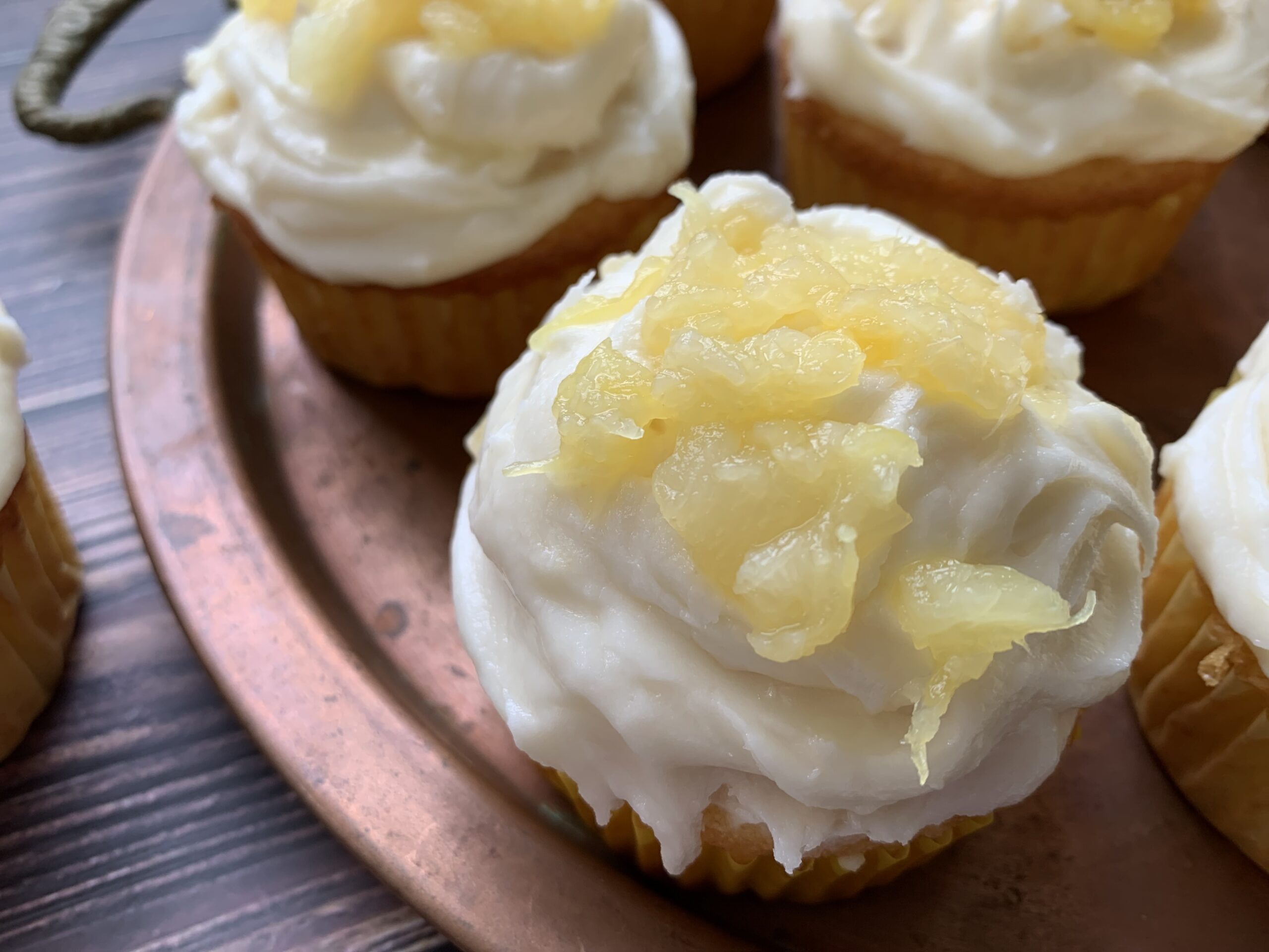 a copper tray, with Pineapple and Rum Cupcakes with Boozy Buttercream