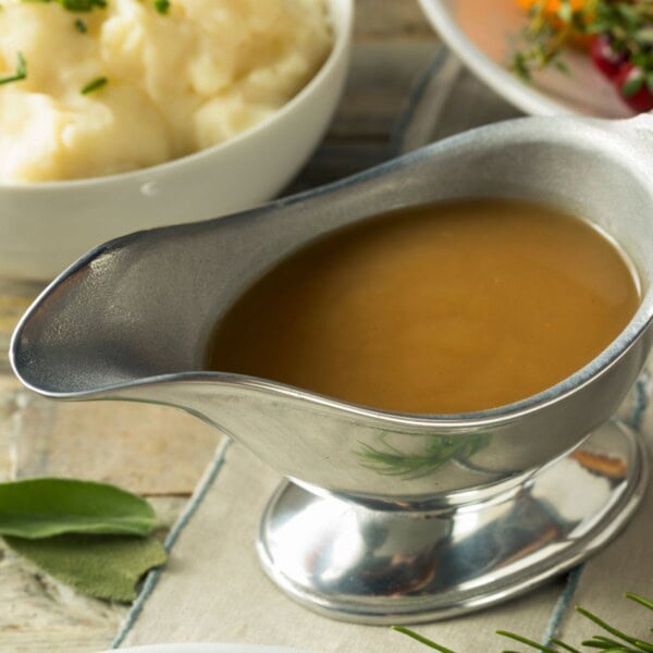 a silver gravy boat, with beef au jus