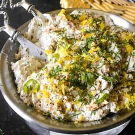 A bowl of dip, with lots of Crab, zested lemon, and captains wafer crackers.
