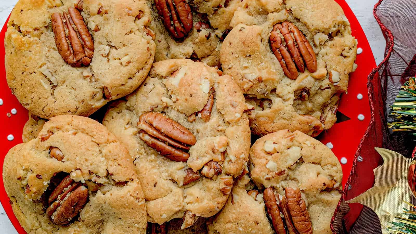 A pile of pecan cookies on a plate.