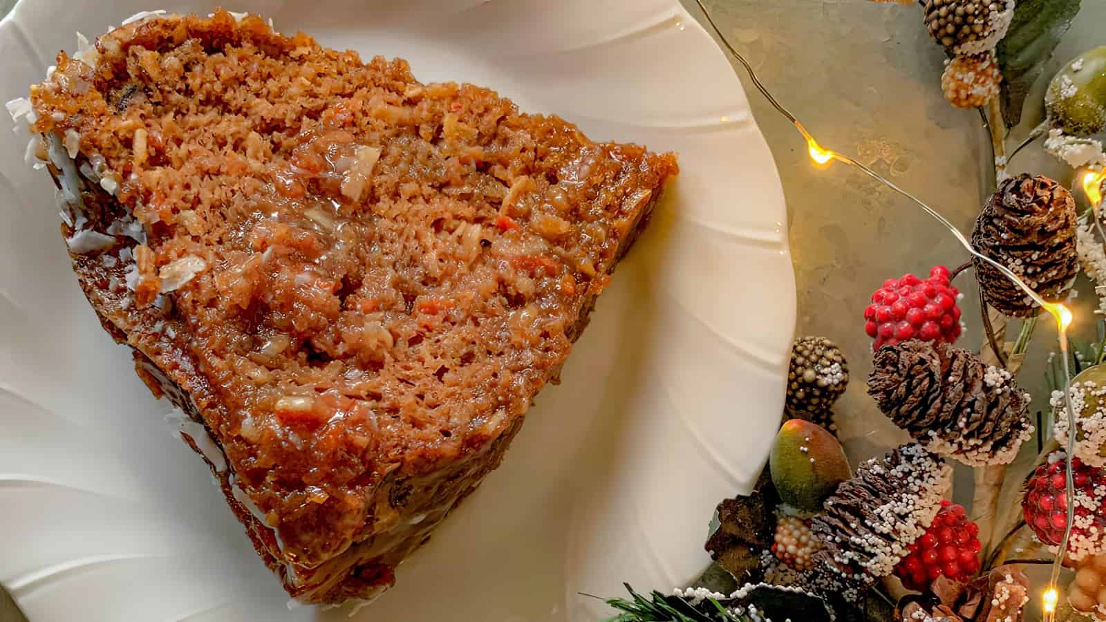A slice of rum-soaked cake with shaved coconut.