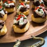 A serving tray filled with beef appetizers.