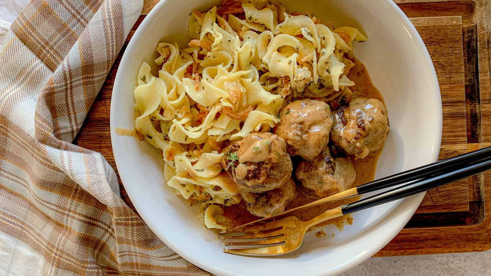 A bowl of French onion noodles alongside creamy Swedish meatballs.
