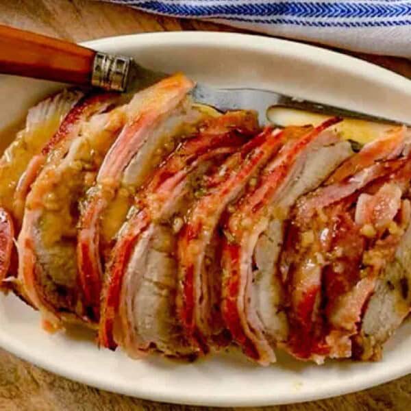 Pork tenderloin slices on a plate.