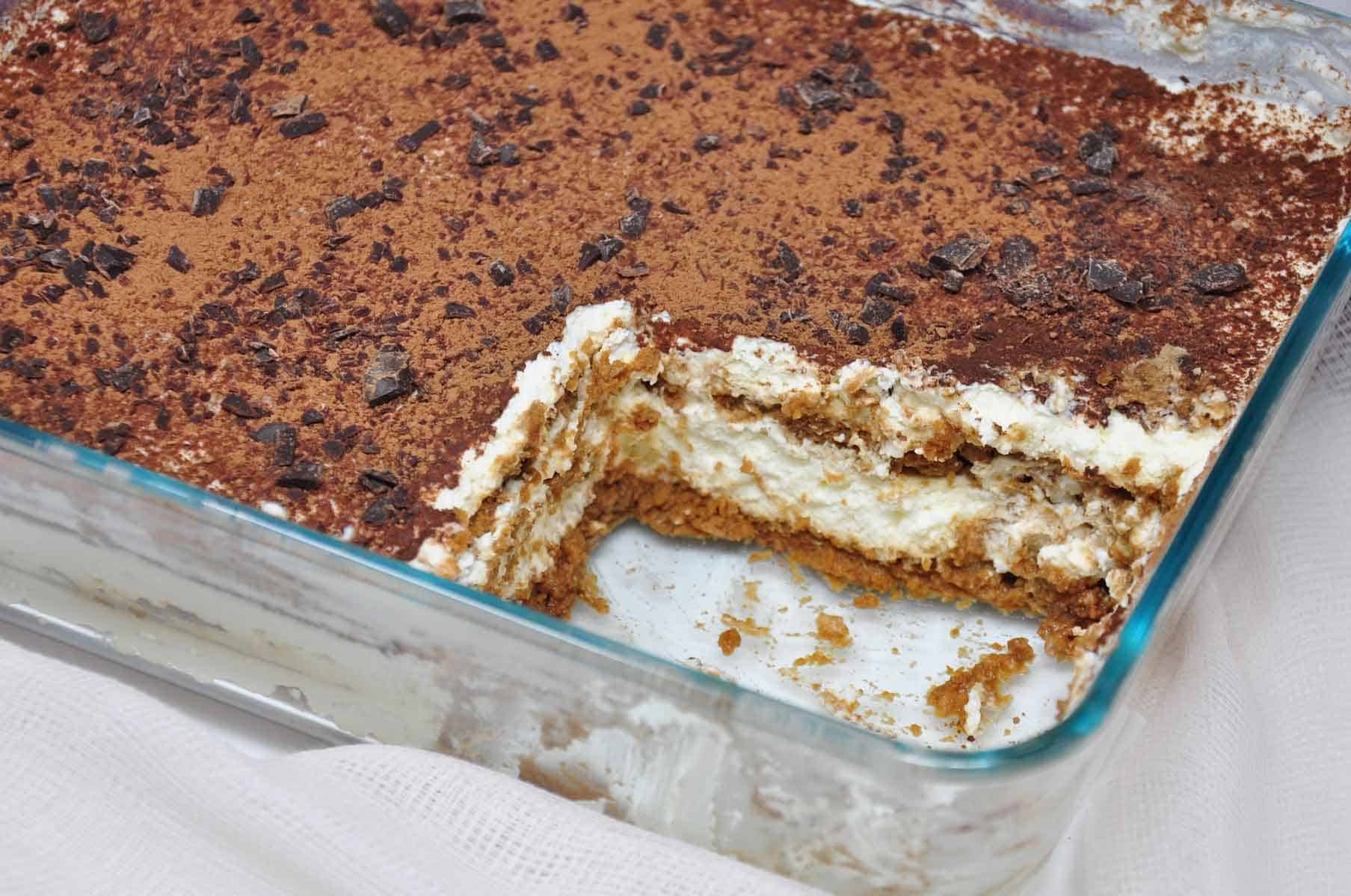 dish of tiramisu with one slice removed.