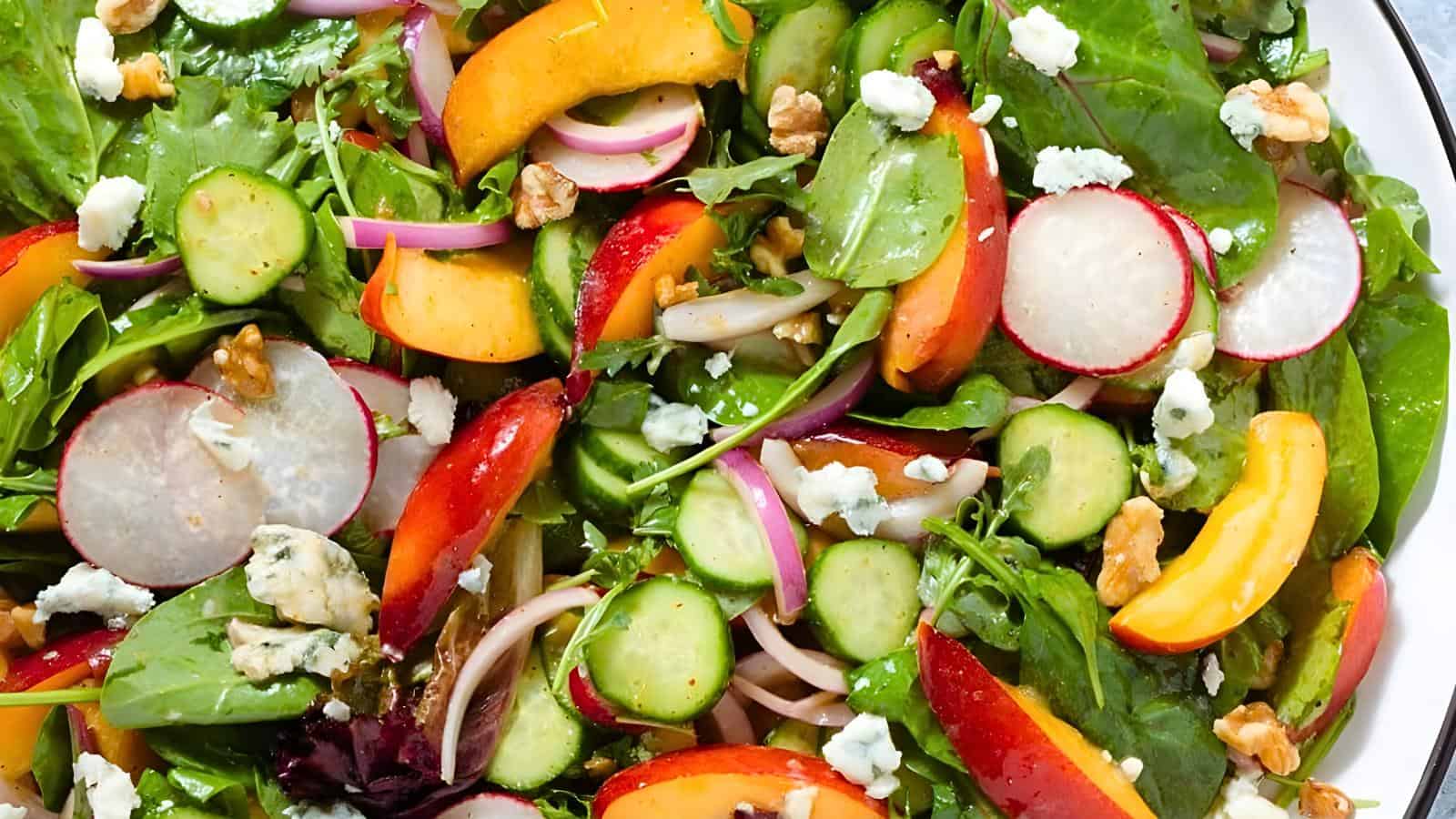 Mixed greens, sliced radishes, cucumbers, red onions, peaches, walnuts, crumbled cheese.