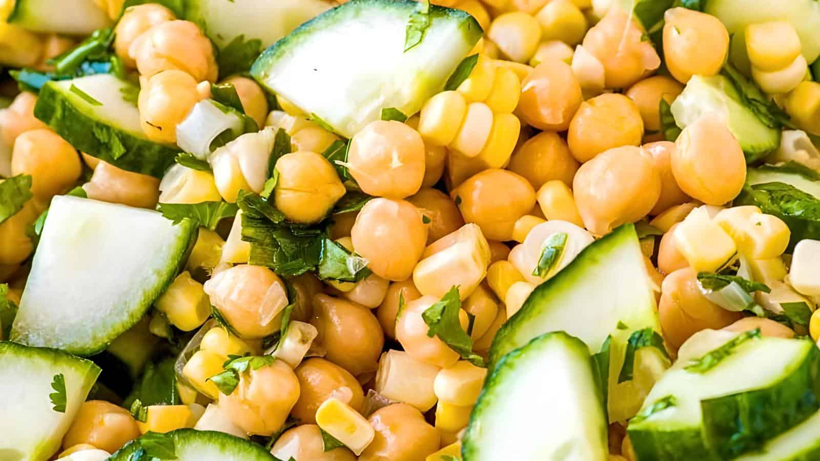 Chickpeas, cucumber slices, corn kernels, chopped herbs.