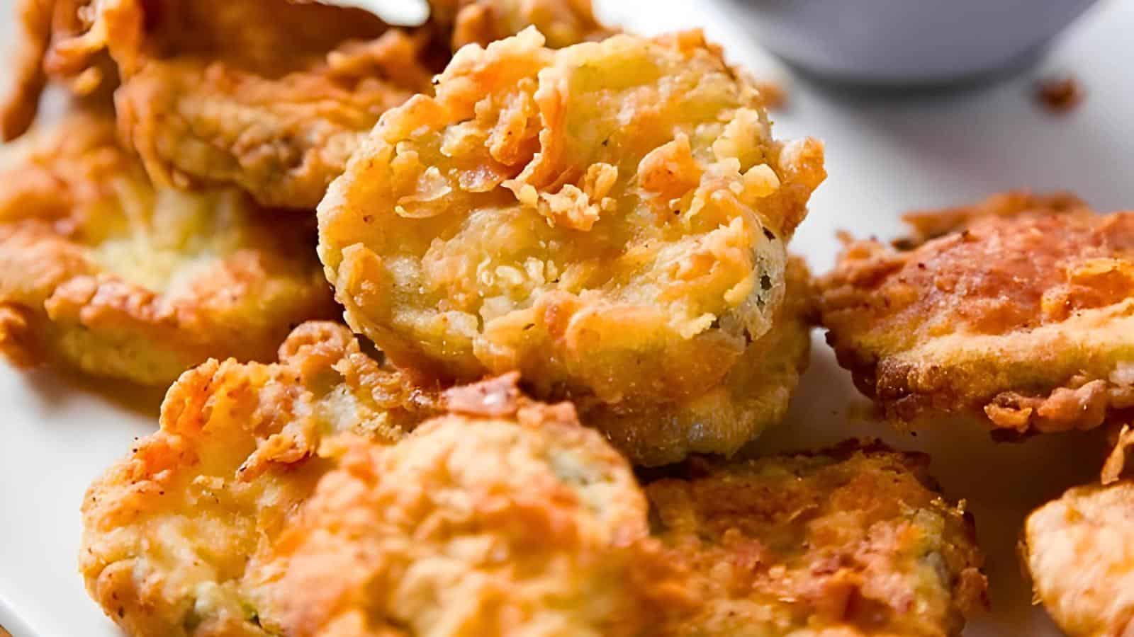 A plate of golden-brown fried pickles showcasing their crispy texture.