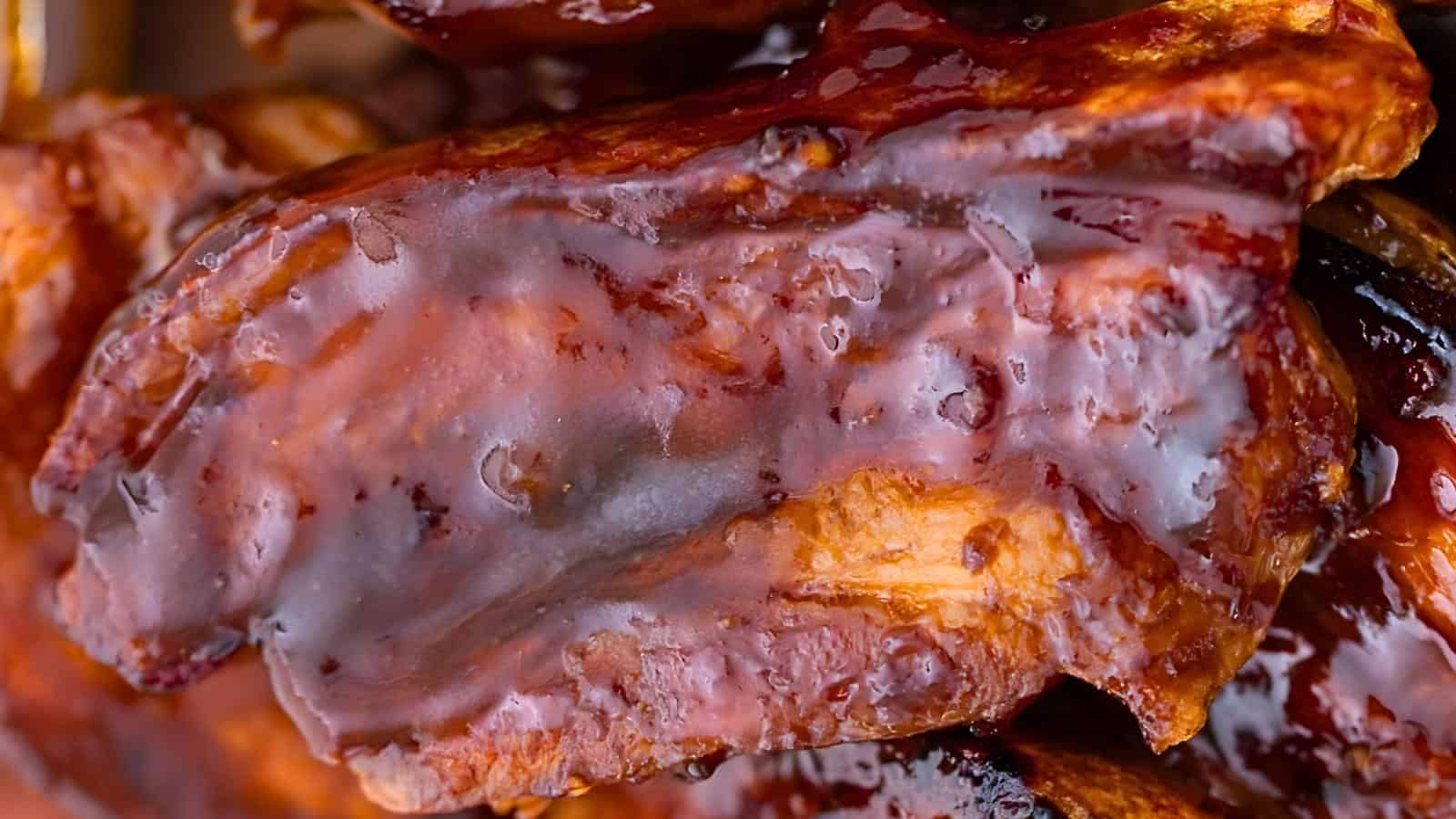 A stack of glazed barbecue with a shiny, caramelized crust and visible meat textures.