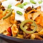 A skillet piled high with pimento cheese nachos.