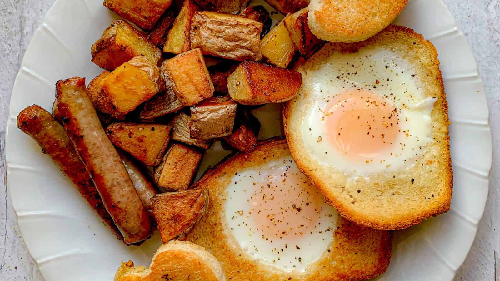 A plate of home fries and sausages with eggs.