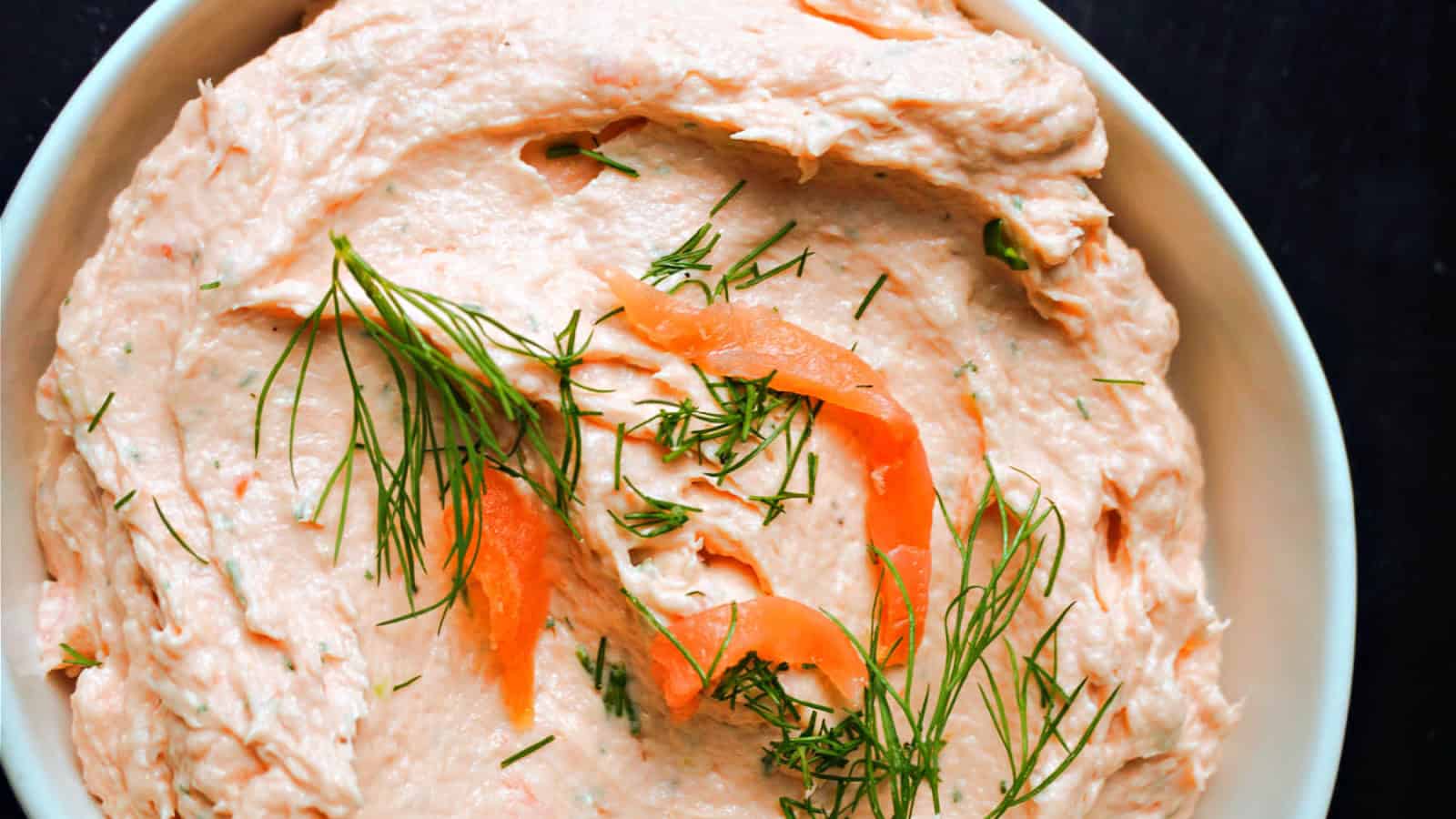 A white bowl with smoked salmon pate.