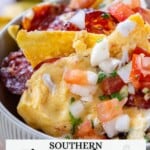 Bowl of nachos with pimento cheese, sliced sausage, chopped tomatoes, onions. Text: "Southern Pimento Cheese Nachos" and "Not Entirely Average".