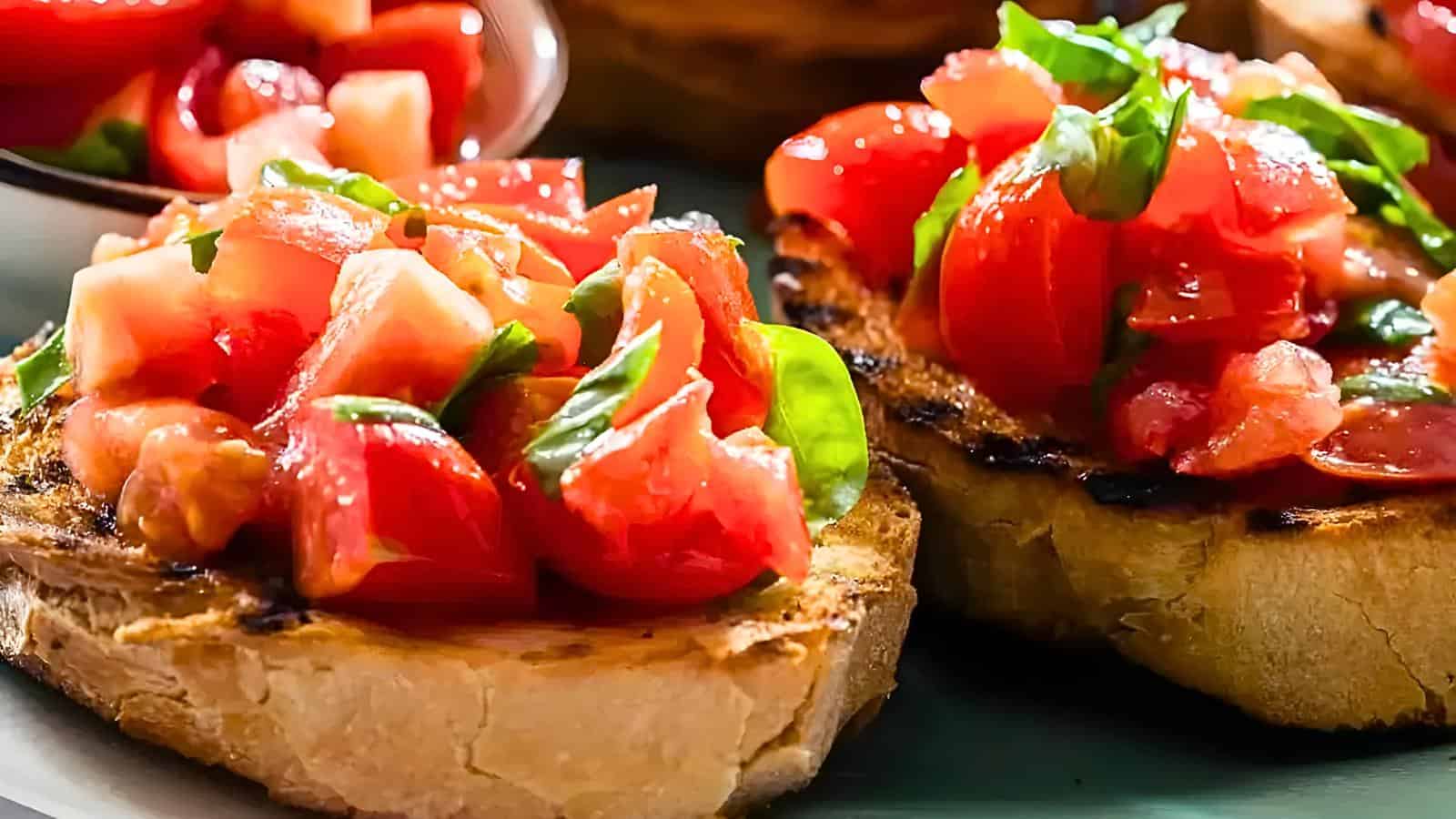 Diced tomatoes, fresh basil leaves, and a drizzle of olive oil on bruschetta.