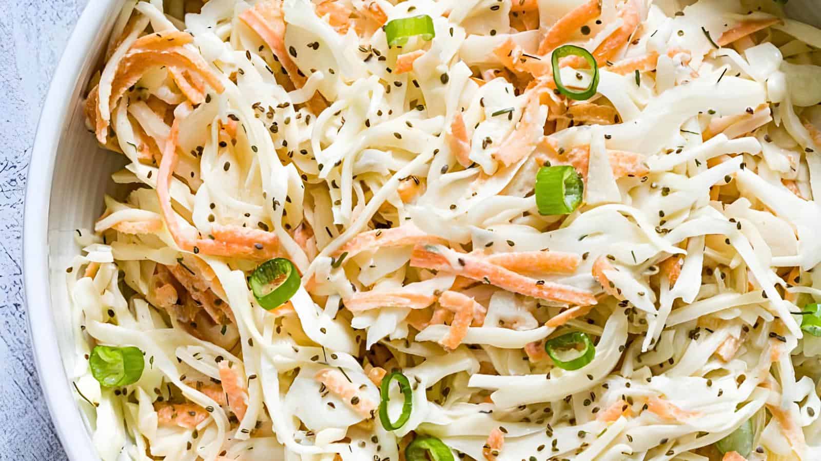 Shredded cabbage, shredded carrots, chopped green onions, and chia seeds.