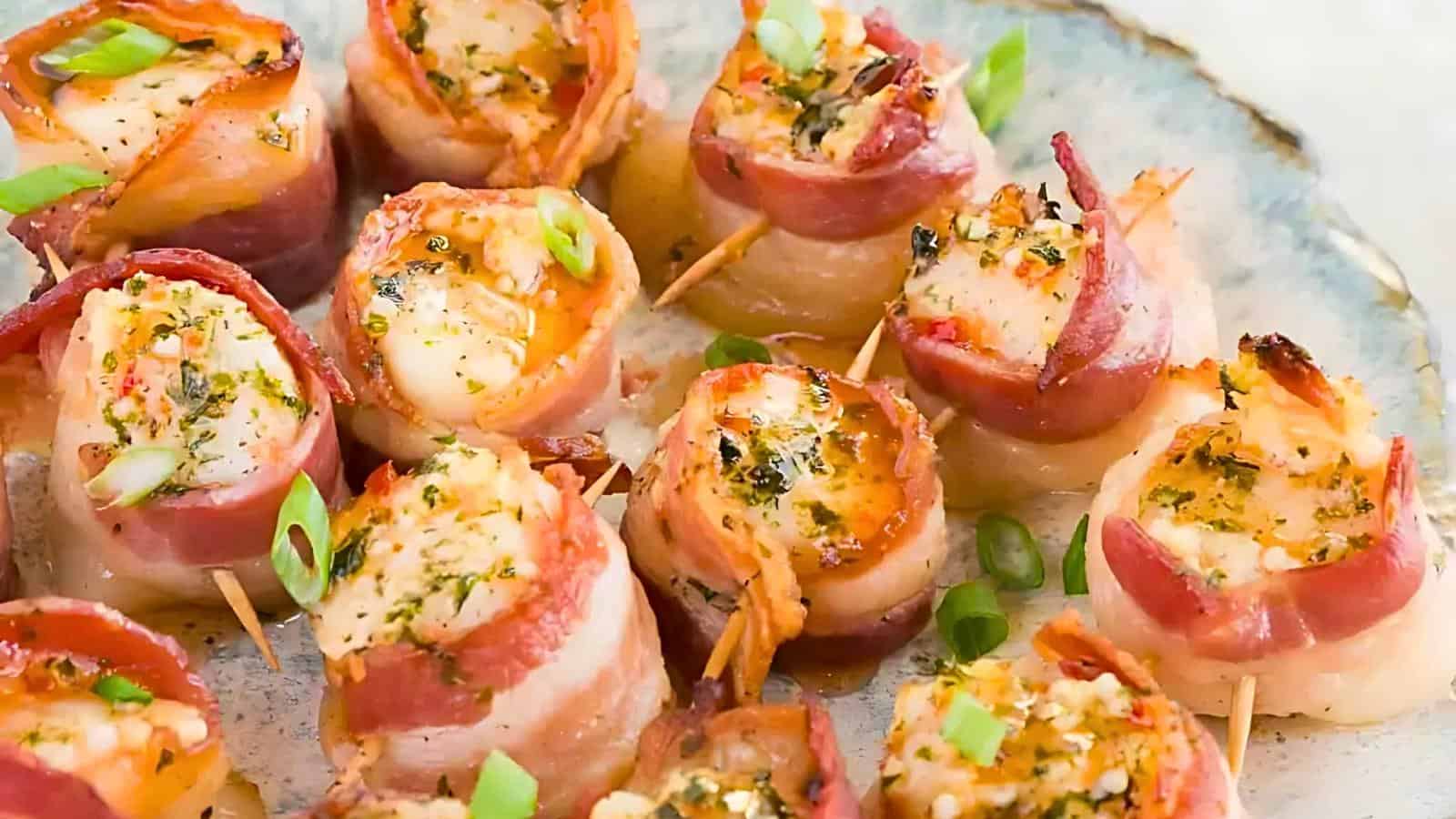 A plate of bacon-wrapped scallops garnished with green onions on a light-colored ceramic dish.