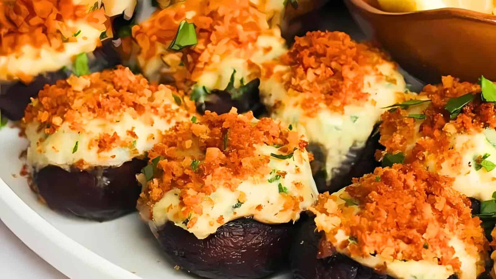 Stuffed mushrooms topped with melted cheese and crispy breadcrumbs, garnished with chopped parsley.
