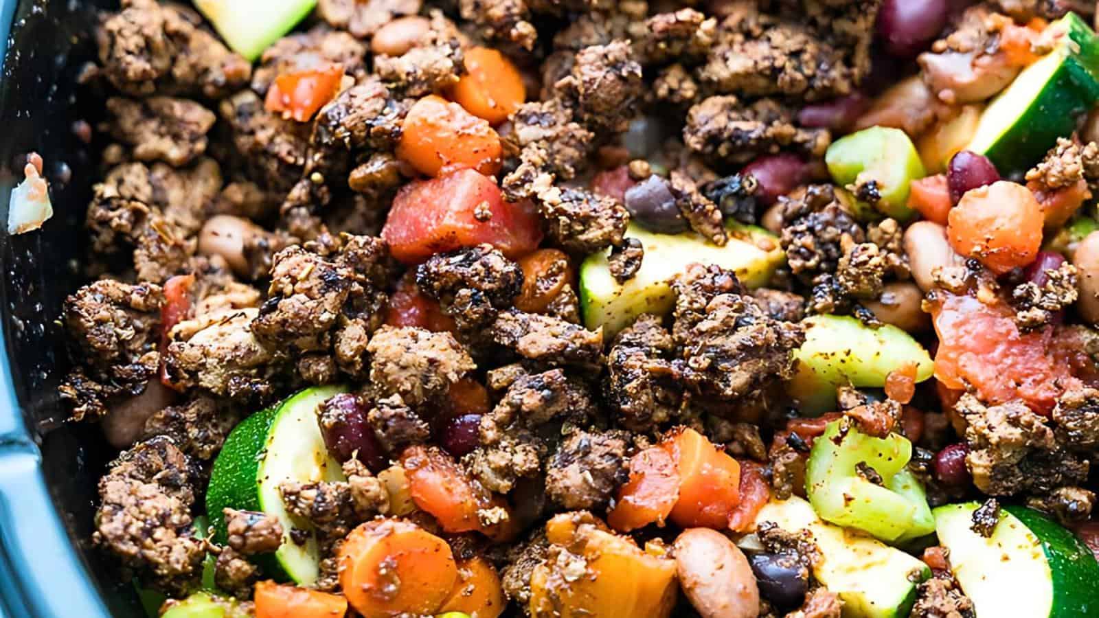 A close-up view of chopped vegetables, mixed beans, and turkey chili.