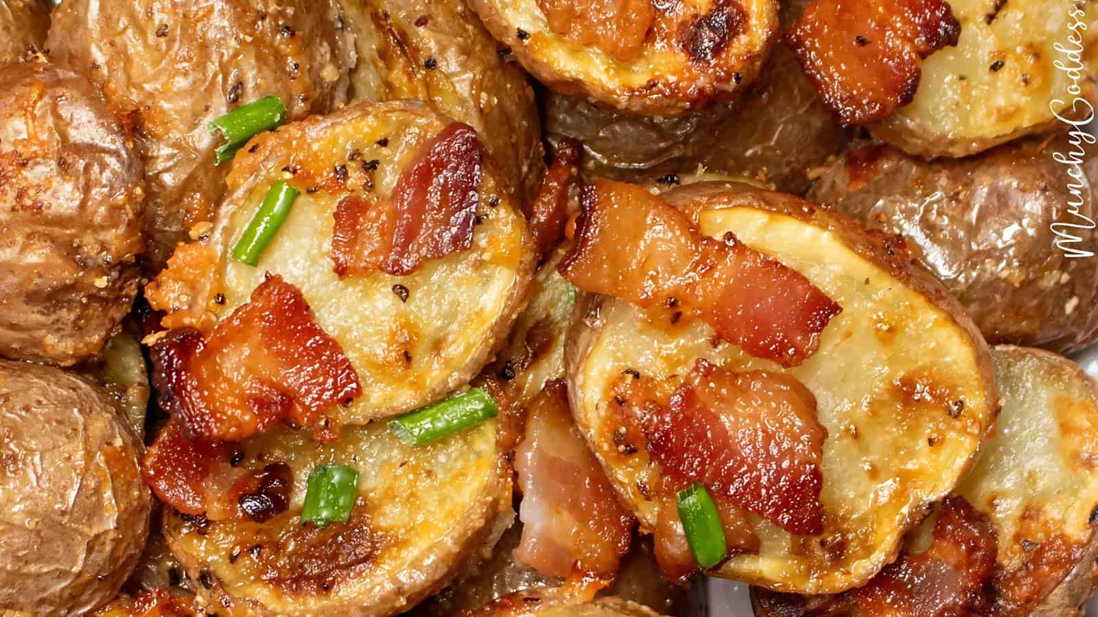 Close-up of loaded baked potato skins topped with melted cheese, crispy bacon pieces, chopped green onions, and black pepper.
