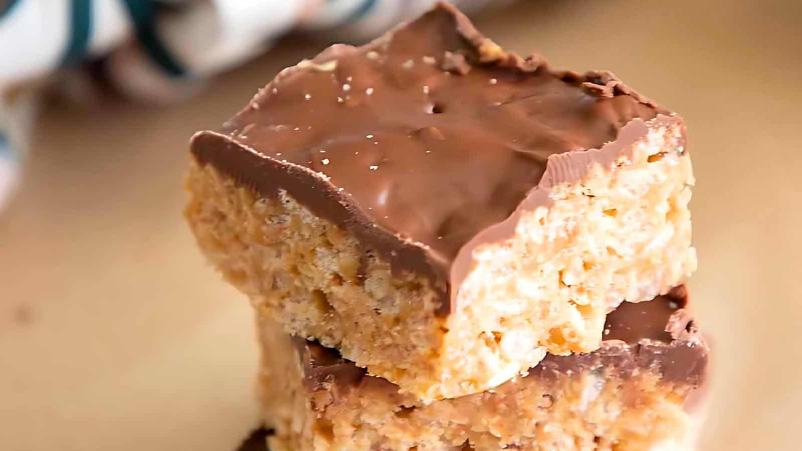 Two stacked chocolate-coated crispy rice treats.