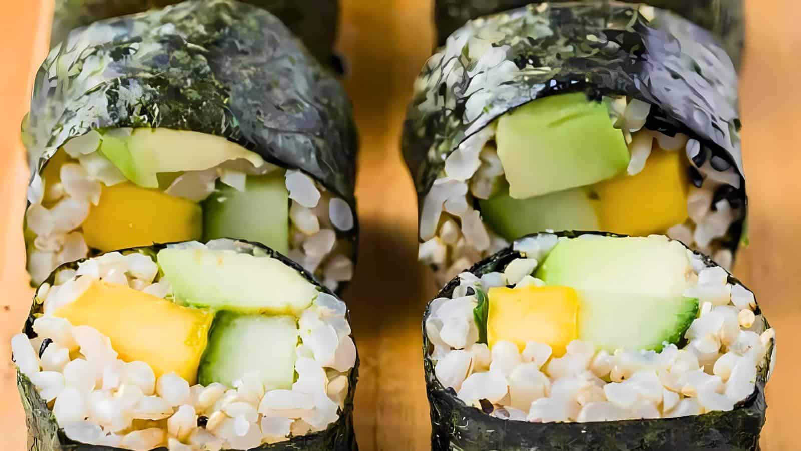 Sushi rolls with rice, cucumber, and mango, wrapped in seaweed.