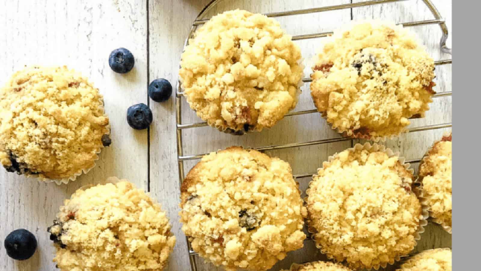 Muffins with fresh blueberries around.
