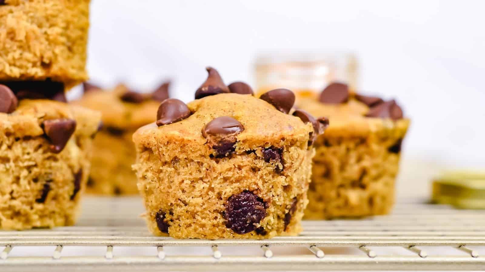 Chocolate chip banana peanut butter muffins on a cooling rack.