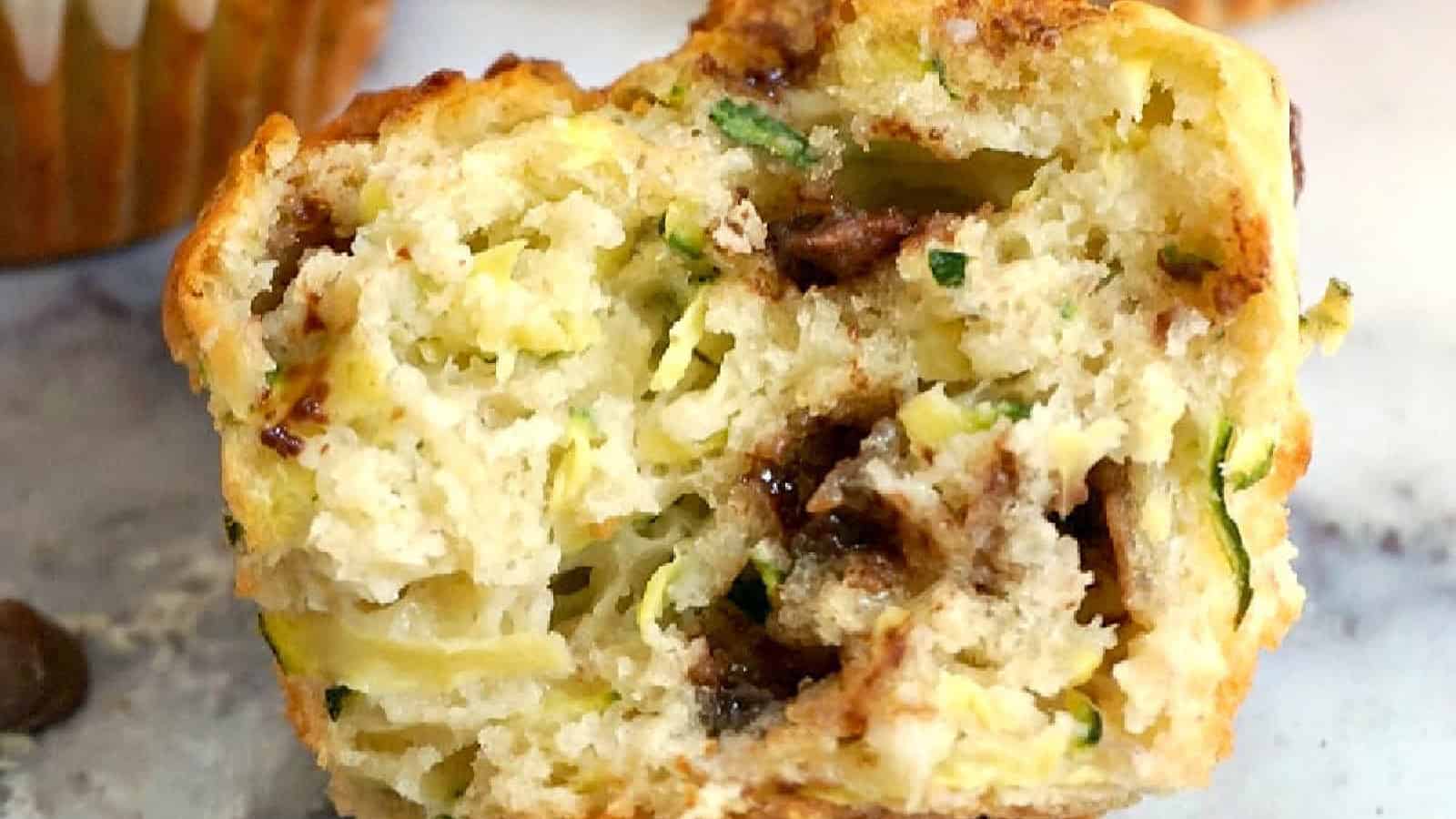 Half of a zucchini and chocolate chip muffin.