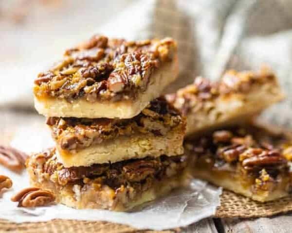 Pecan pie bars stacked on top of one another.