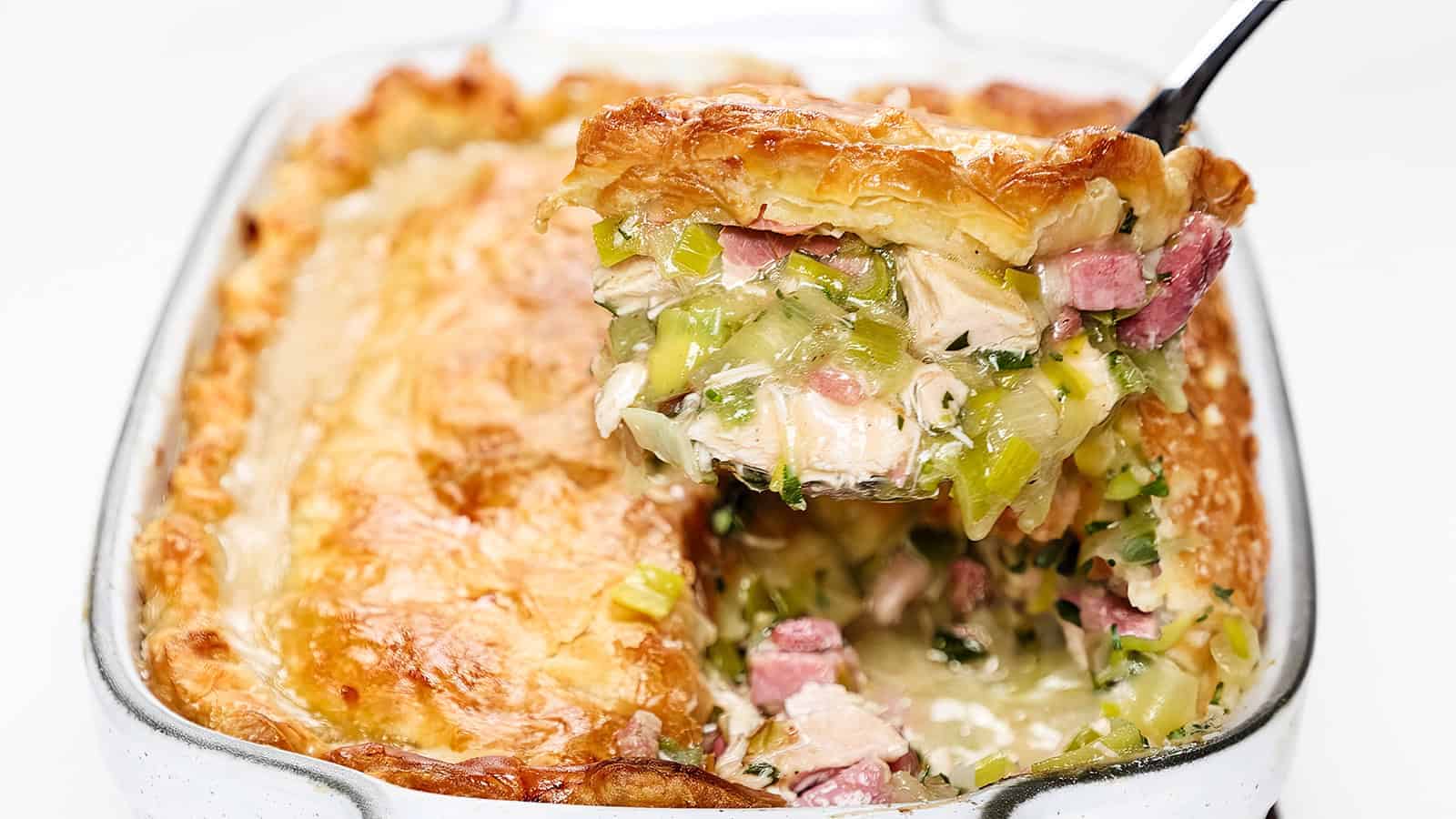Ham and turkey pot pie with a spoon.