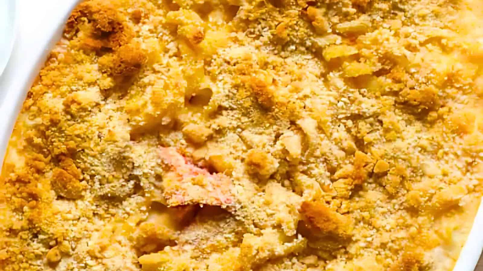 A close-up view of a baked macaroni and cheese dish with a golden-brown breadcrumb crust. The surface displays a crunchy texture with some areas slightly more browned, giving it a crispy and appetizing appearance.