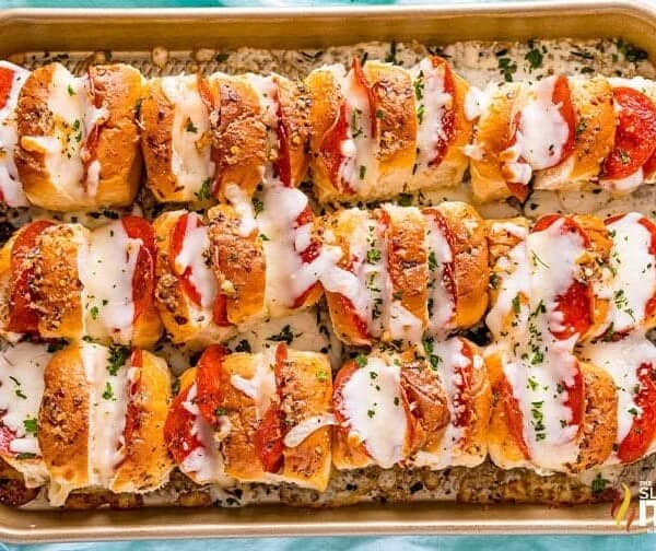 A sheet pan with cheesy pull apart bread and garlic butter.