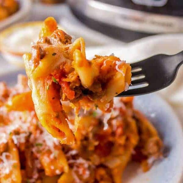 Slow Cooker Cheesy Penne with meat sauce and parmesan cheese.