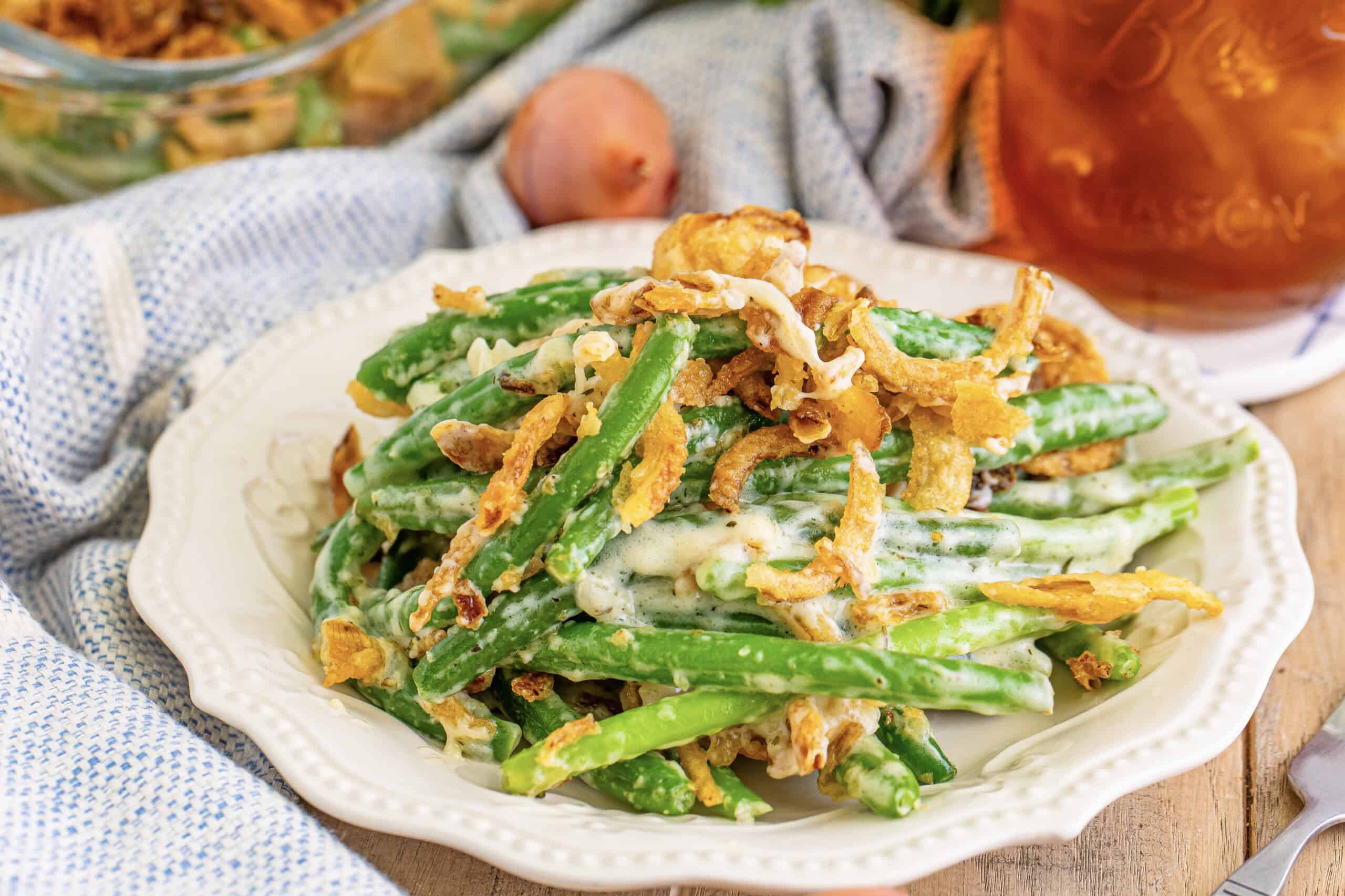 A plate containing green bean casserole with a topping of crispy fried onions.