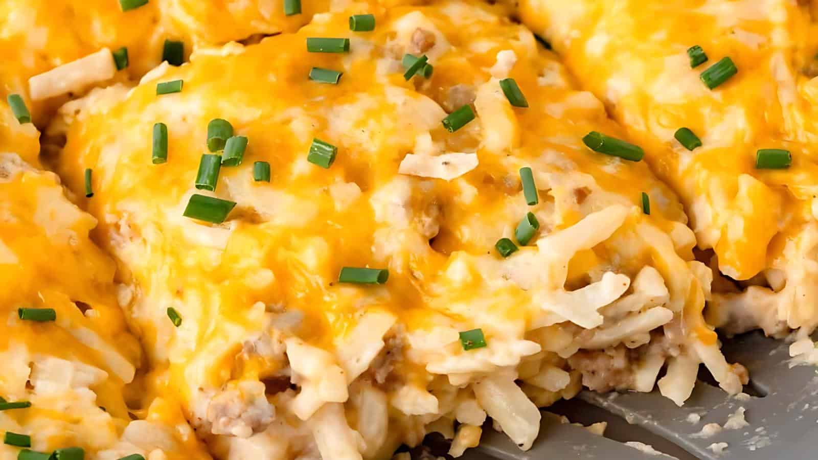 A close-up image shows a baked casserole featuring melted cheese, hash browns, and a sprinkle of chives.