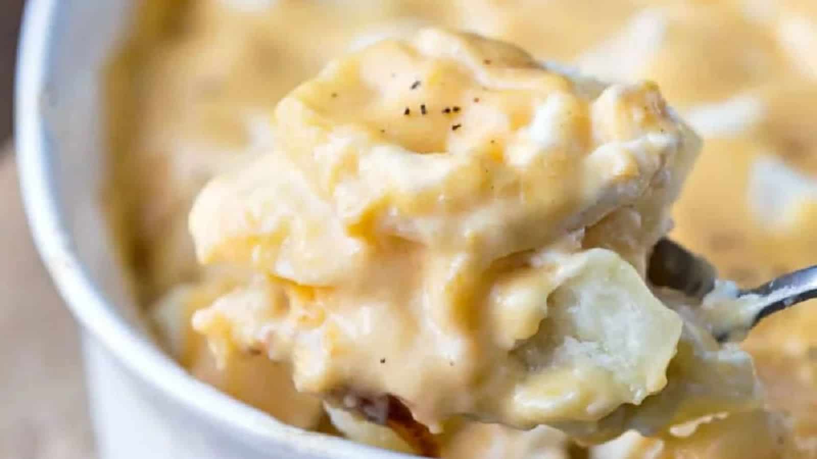 A spoonful of creamy macaroni and cheese, featuring cheesy, gooey noodles with a hint of black pepper.