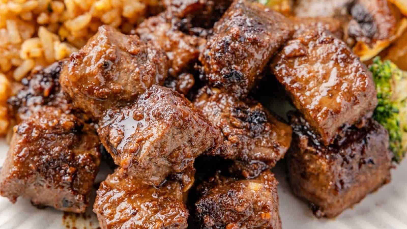 Grilled steak bites glazed with sauce, served with rice and broccoli.